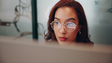a woman working on a computer in an office