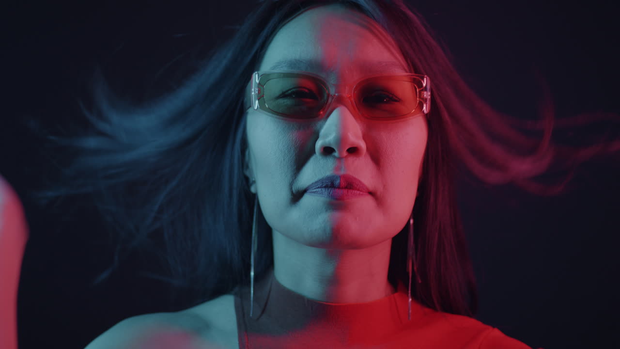 Stylish Woman with Neon Lighting and Sunglasses