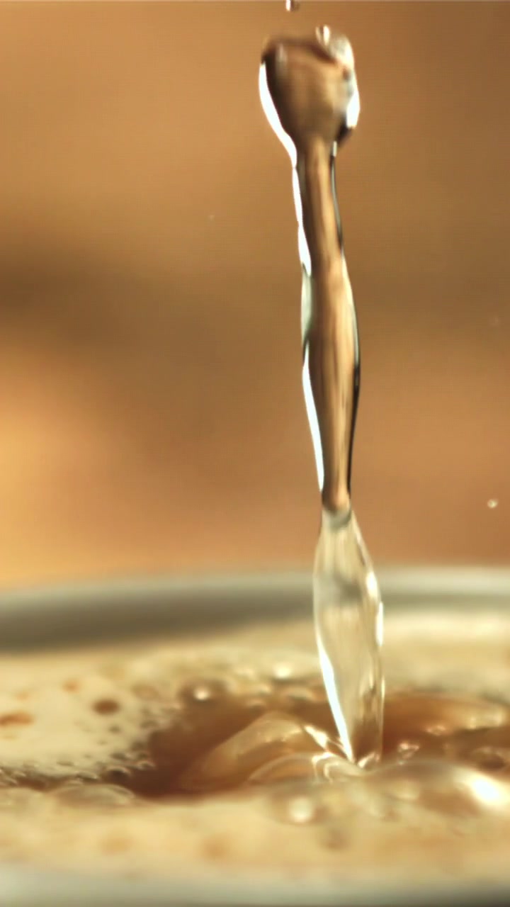 Slow Motion Liquid Drops Splashing into a Coffee Beverage