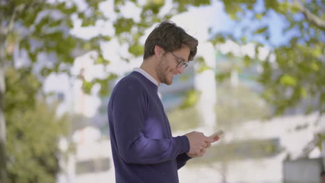 smiling man using cell phone outdoor