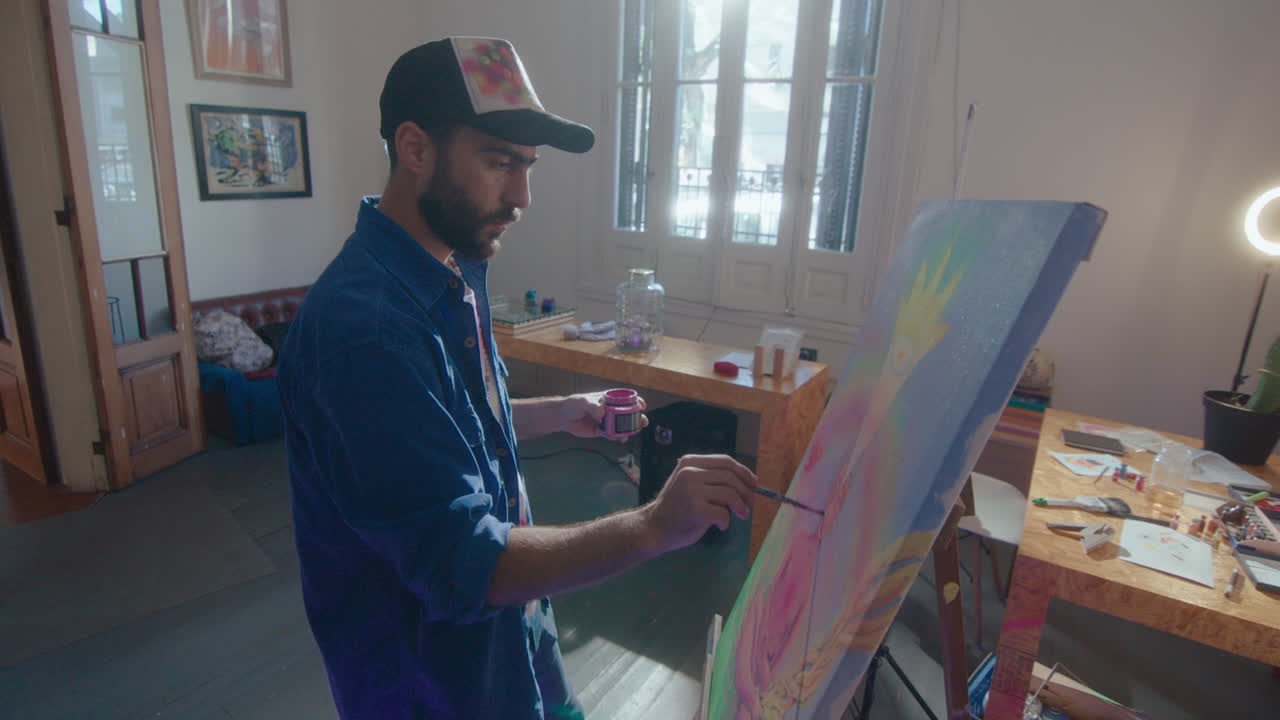 Professional Painter Painting Picture on Canvas in Art Studio