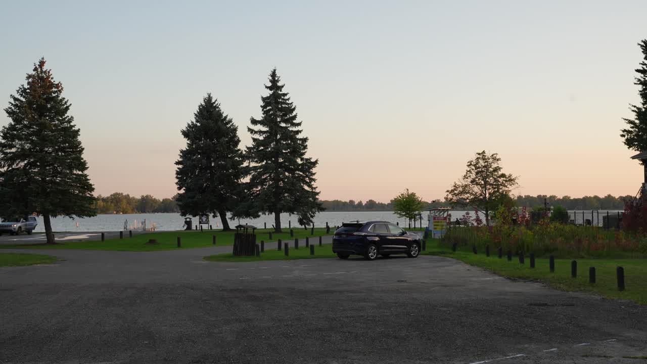 A car pulling into a parking lot at a lake in Michigan