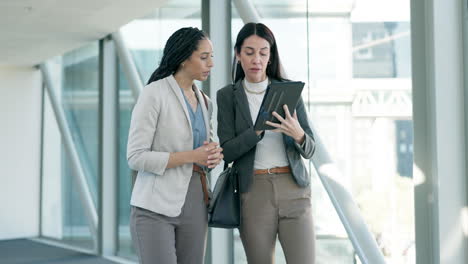 business, women walking and talking with tablet