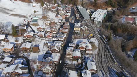 aerial view of lauterbrunnen switzerland in winter season | moving overhead towards central train station