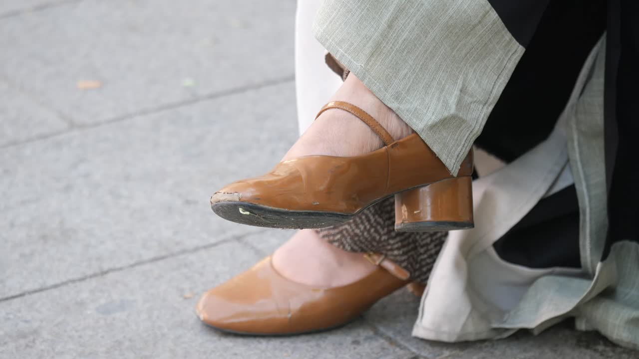 Close-up of brown Mary Jane shoes with heels