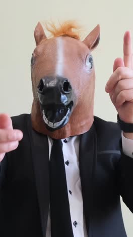 a strange man in a costume and a horse mask dancing cheerfully on a white background a strange man in a costume and a horse mask dancing cheerfully on a white background crazy man a horses face positive emotions