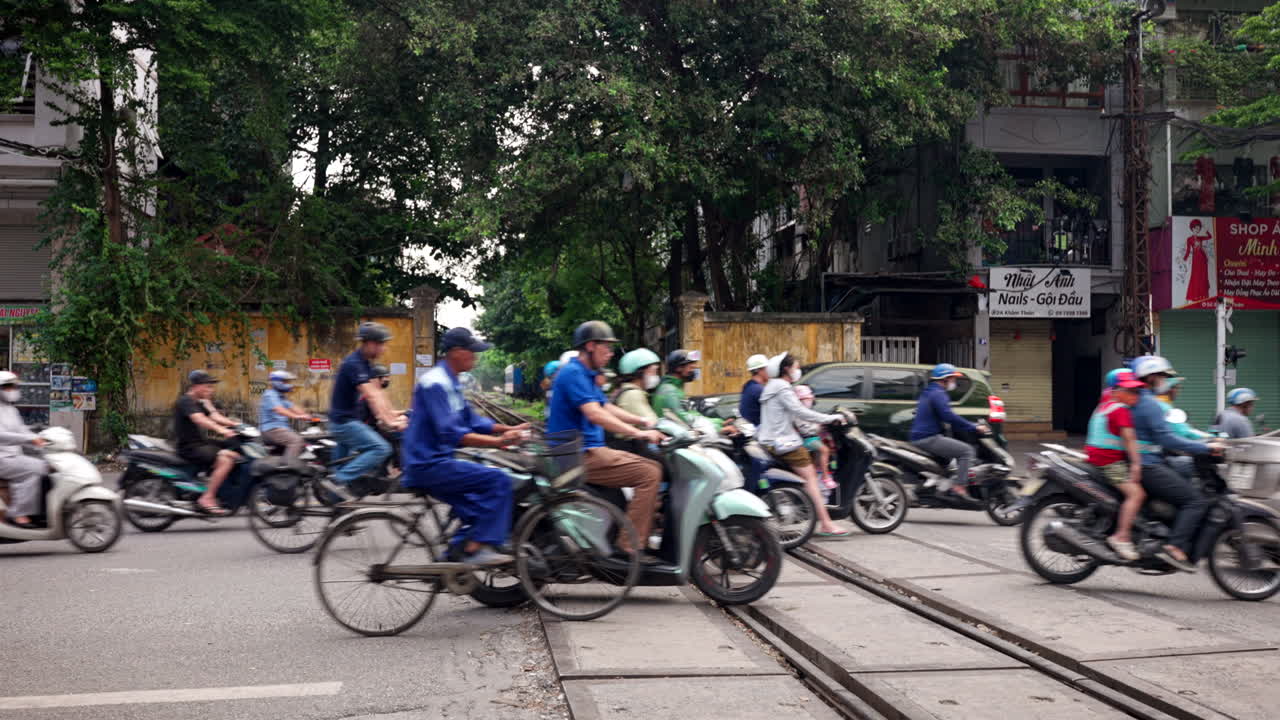 Two wheeled urban transport crossing busy train street location