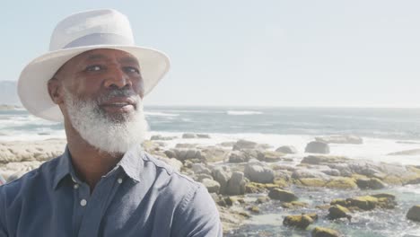 Portrait-of-senior-african-american-man-on-promenade-by-the-sea,-copy-space,-slow-motion