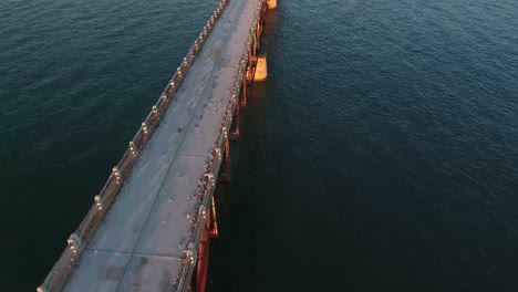 AERIAL:-Drone-flyover-of-an-old-broken-down-bridge-over-the-ocean