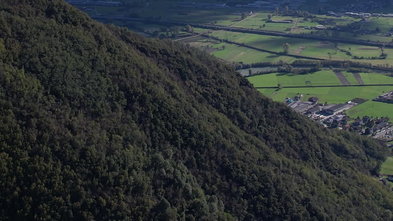Stunning aerial view of Italian Alps covered in lush greenery