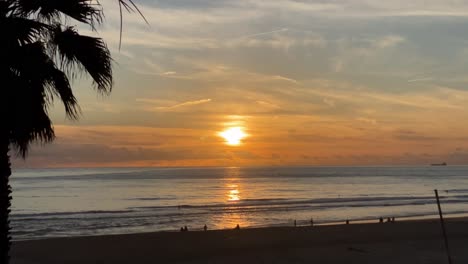 Sunset-at-Cascais-beach,-sun-reflecting-on-sea-water,-romantic-evening-in-Atlantic-coast