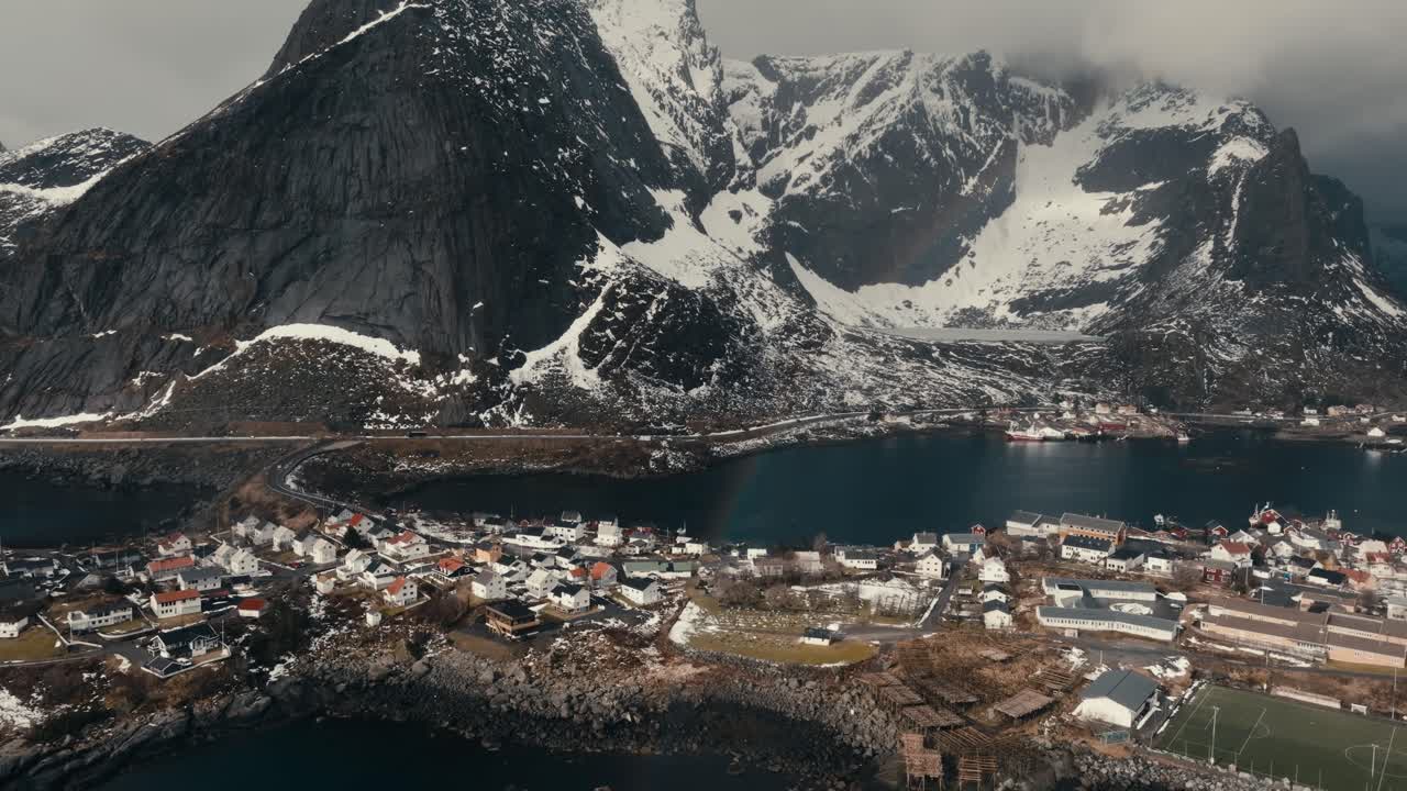 Snowy Rocky Mountains And Reine Village In Nordland, Norway. - aerial shot