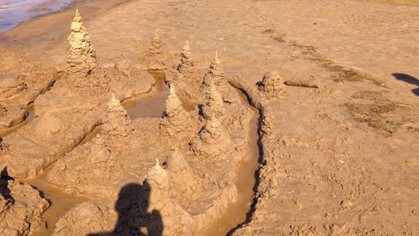 remnants of washed-away sandcastle, now in a state of gradual crumbling