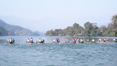 people competing in a boat race at fewa lake