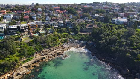 oceanfront hotels and buildings on the cliff with a view of beach - gordon's bay in coogee, new south wales, australia