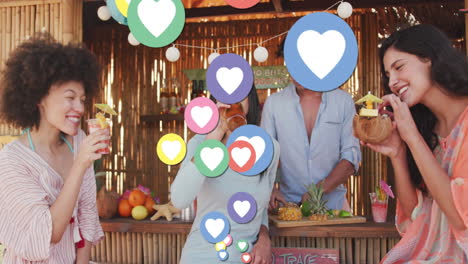 animation of heart digital icons over friends having party in beach bar