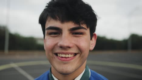 portrait of happy young teenager smiling in front of camera