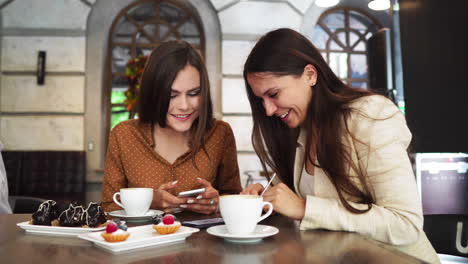 happy colleagues from work socializing in restaurant and eating together