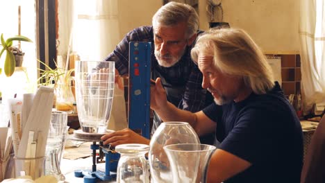 glassblowers working on a glass vase