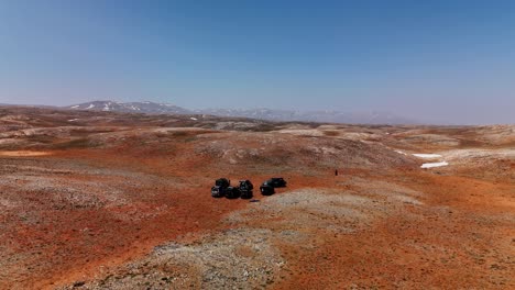 aerial view of atvs on rocky desert under clear blue sky