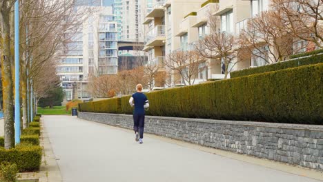 man jogging on the sidewalk in the city 4k 4k