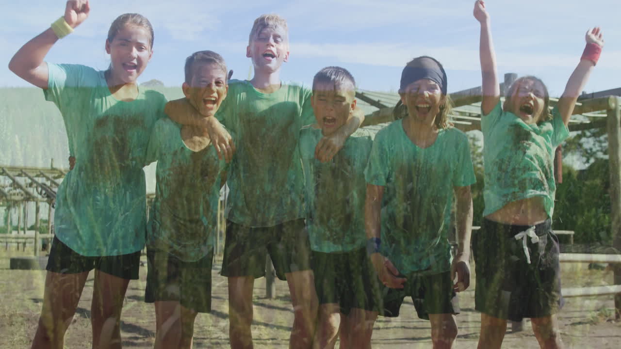 Cheering outdoors, group of children in green shirts showing excitement
