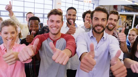 Portrait-of-business-team-gesturing-together-in-office