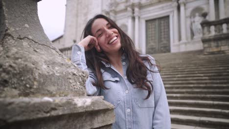 fashion model in denim blushing looking towards the camera at spain