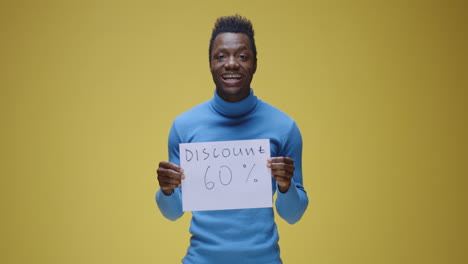 man showing a "60% discount" sign