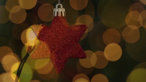 Animation-of-red-star-christmas-decoration-with-multiple-flickering-yellow-spots-of-light