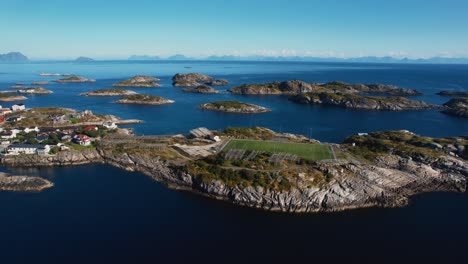 henningsvær at lofoten islands, norway. island, harbor, and iconic football field. aerial drone.