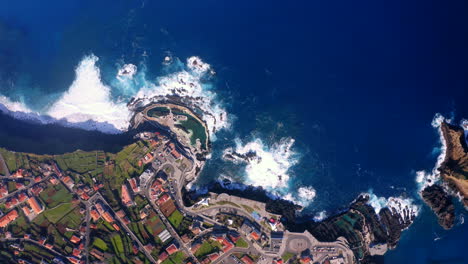 aerial top down view showing blue atlantic ocean and beautiful landscape of porto moniz on madeira island during sun