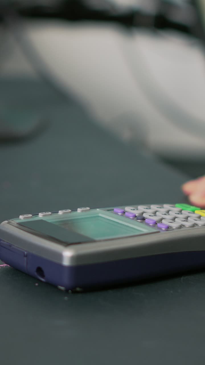 Vertical video: Male client using credit card on pos to pay for medicine