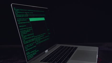 Hacker Concept. Code On A Laptop Computer Monitor In A Dark Room
