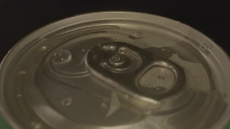 close macro view of droplets on top of spinning soda can