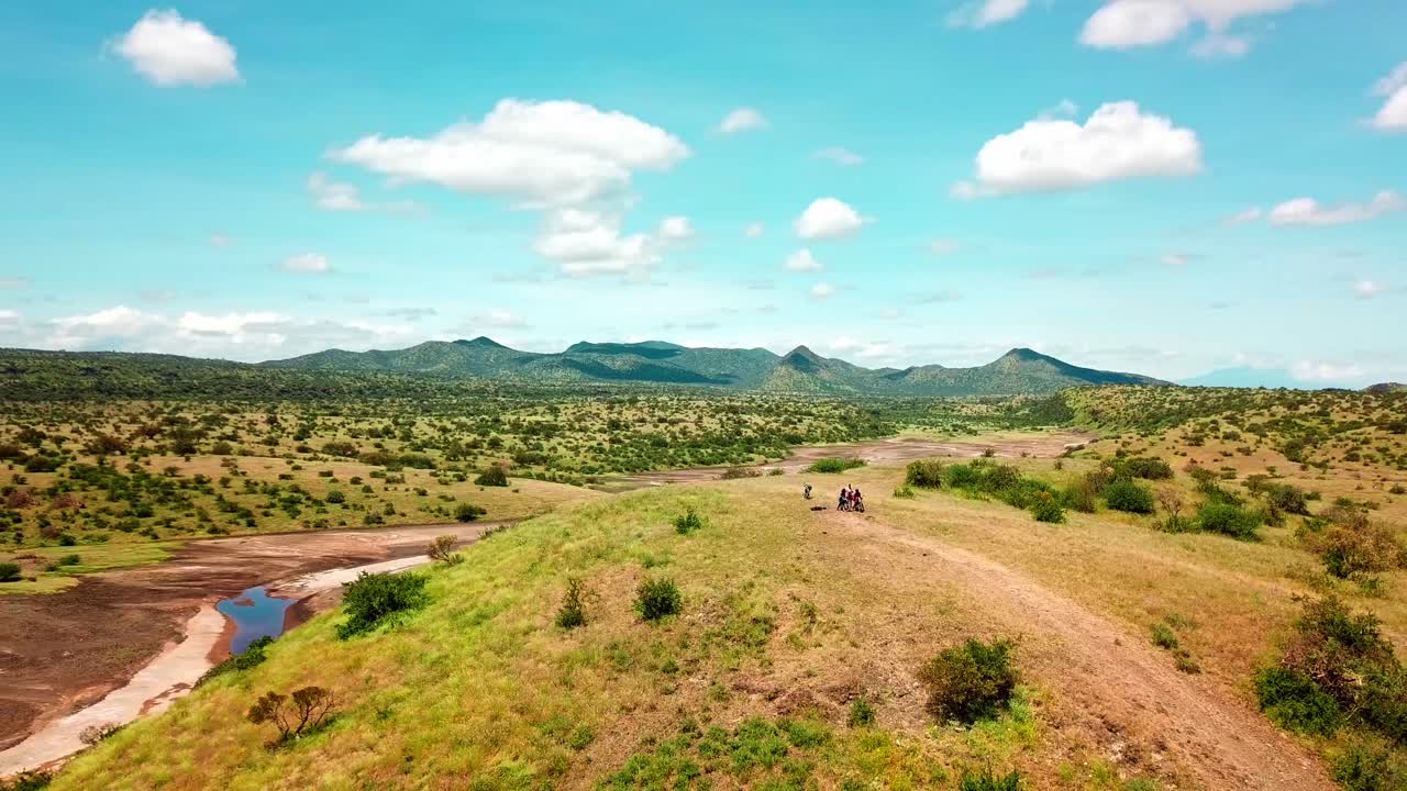 Motorcycle Riders On The Slope Mountains Around Lake Magadi Soda In Kenya, East Africa. Aerial Pullback