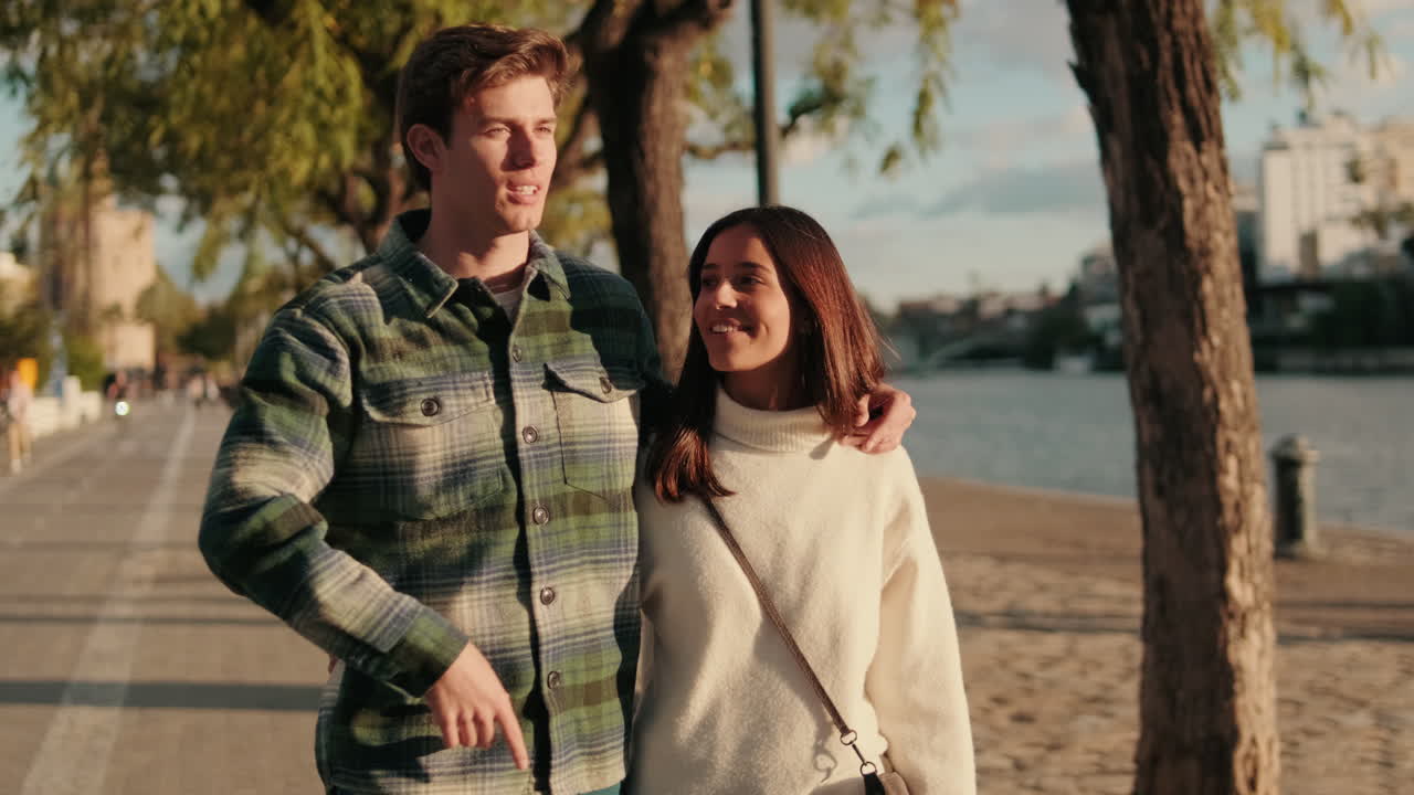 Couple Strolling Along the Guadalquivir River in Seville
