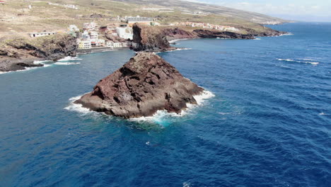 roques de fasnia, tenerife: aerial view traveling out to the rock formations of fasnia, on the coast of santa cruz de tenerife, on a sunny day