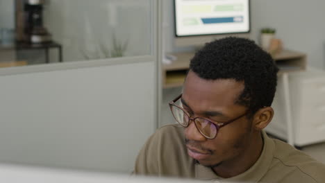 Top-View-Of-Man-Working-Using-Pc-Sitting-At-Desk-In-The-Office