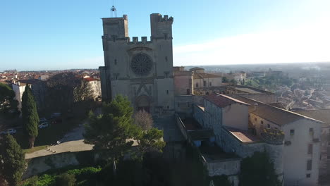 drone aerial track towards béziers cathedral sunny day