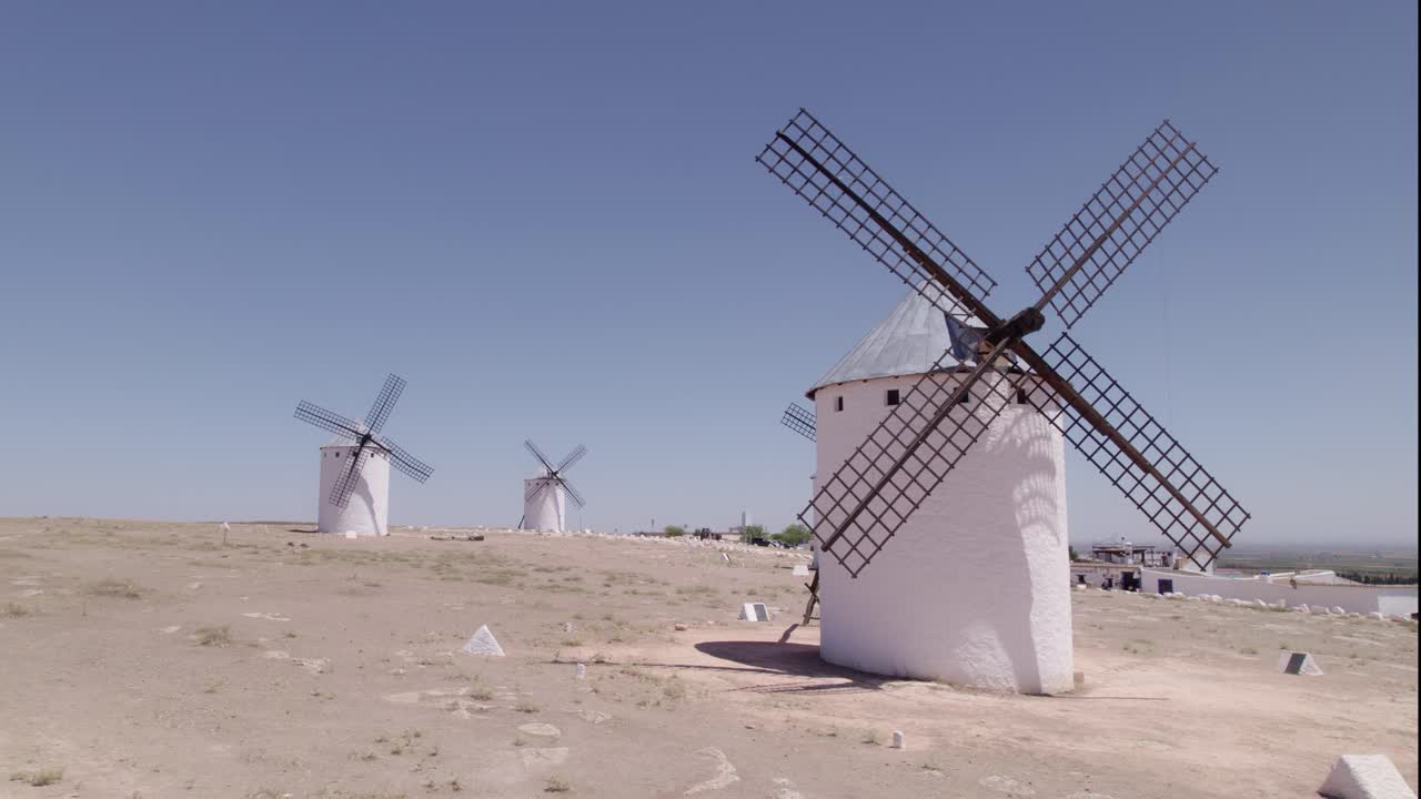 Panoramic view of ancient windmills at midday. La Mancha. Typical Spanish windmills. Aerial tracking shot. Don Quixote. Campo de Criptana. Spain