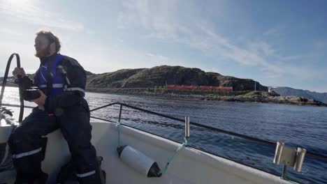 traveler with camera sailing during sunny day on calm lake in norway