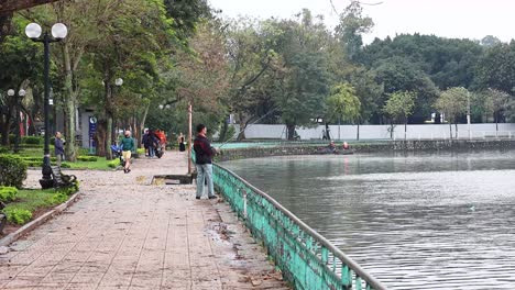 people fishing along a scenic riverside path