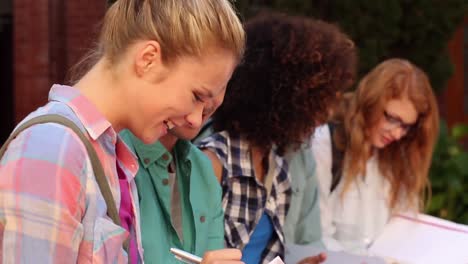 students sitting in a row writing in notebooks