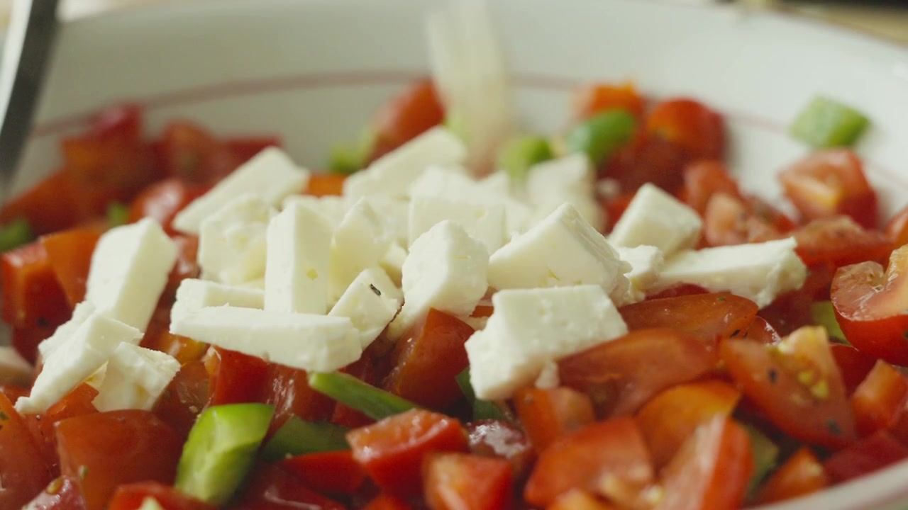 Fresh vegetable and cheese salad being plated and served.
Homemade healthy meal prepared in the kitchen. Close up