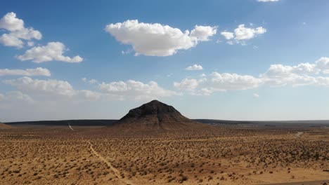 aerial hyperlapse, clouds rolling over lone mountain, mojave desert, california