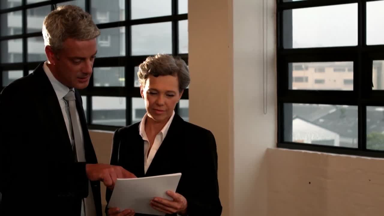 Business couple looking at document