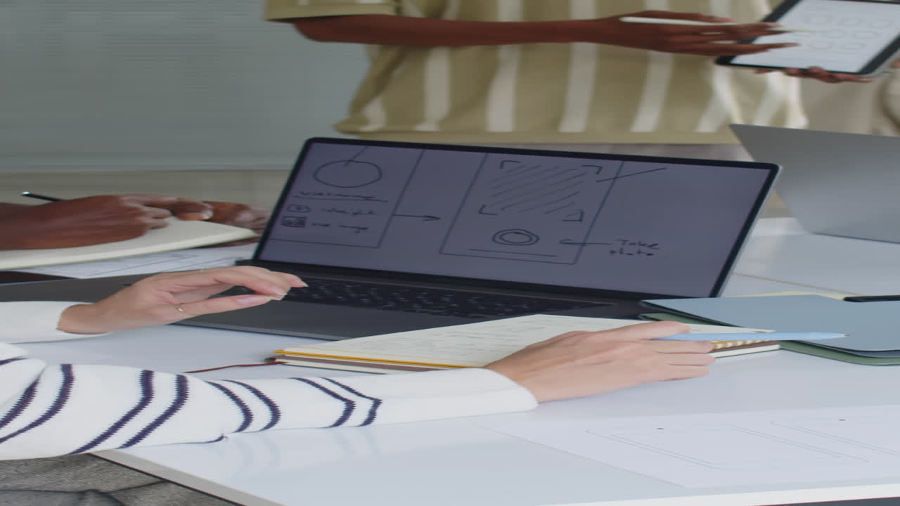 Male Developer Presenting App Interface for Coworkers