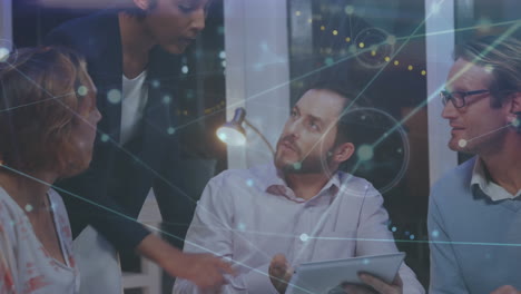 animation of network of connections over diverse businesspeople discussing over documents at office