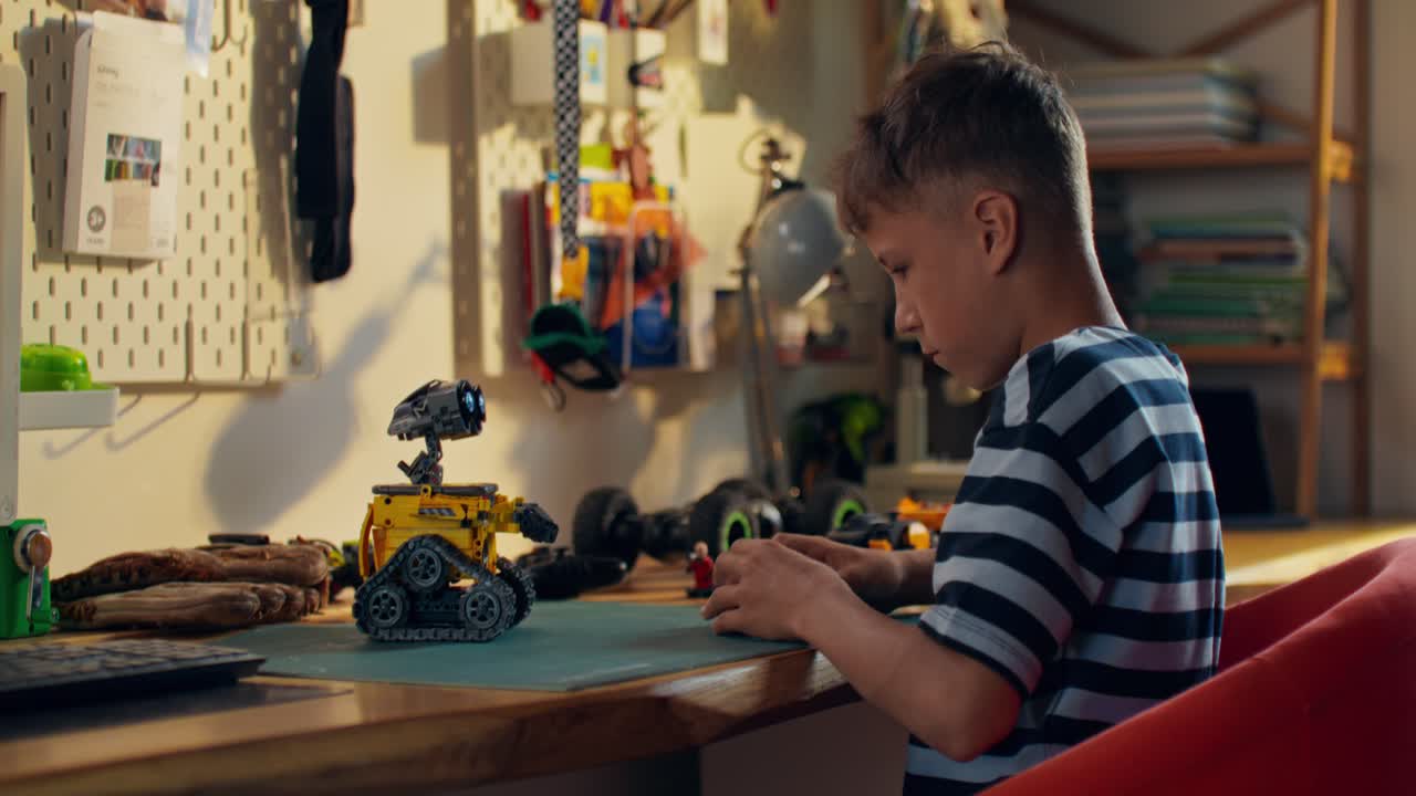 Boy Building Robot Toy at Desk
